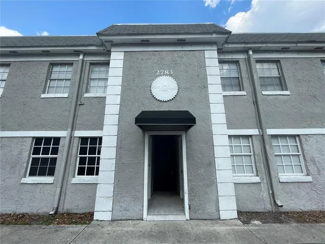 a view of a building with a door and a window