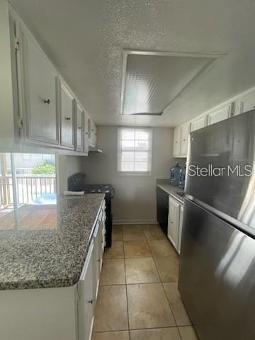 2783 L B McLeod Road, Unit D Orlando, FL 32805 - Photo 3 of 12 a kitchen with granite countertop a sink a stove and a refrigerator
