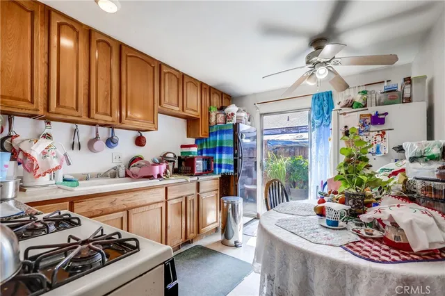 a kitchen that has a lot of cabinets a stove and a window