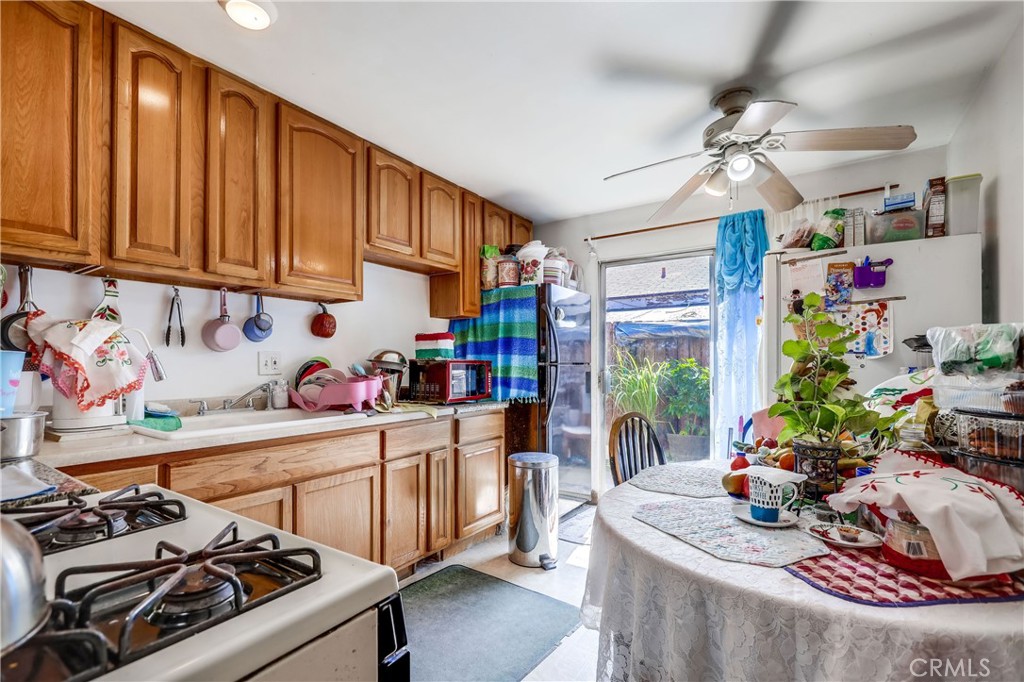 1813 Cedar Street Santa Ana, CA 92707 - Photo 3 of 6 a kitchen that has a lot of cabinets a stove and a window