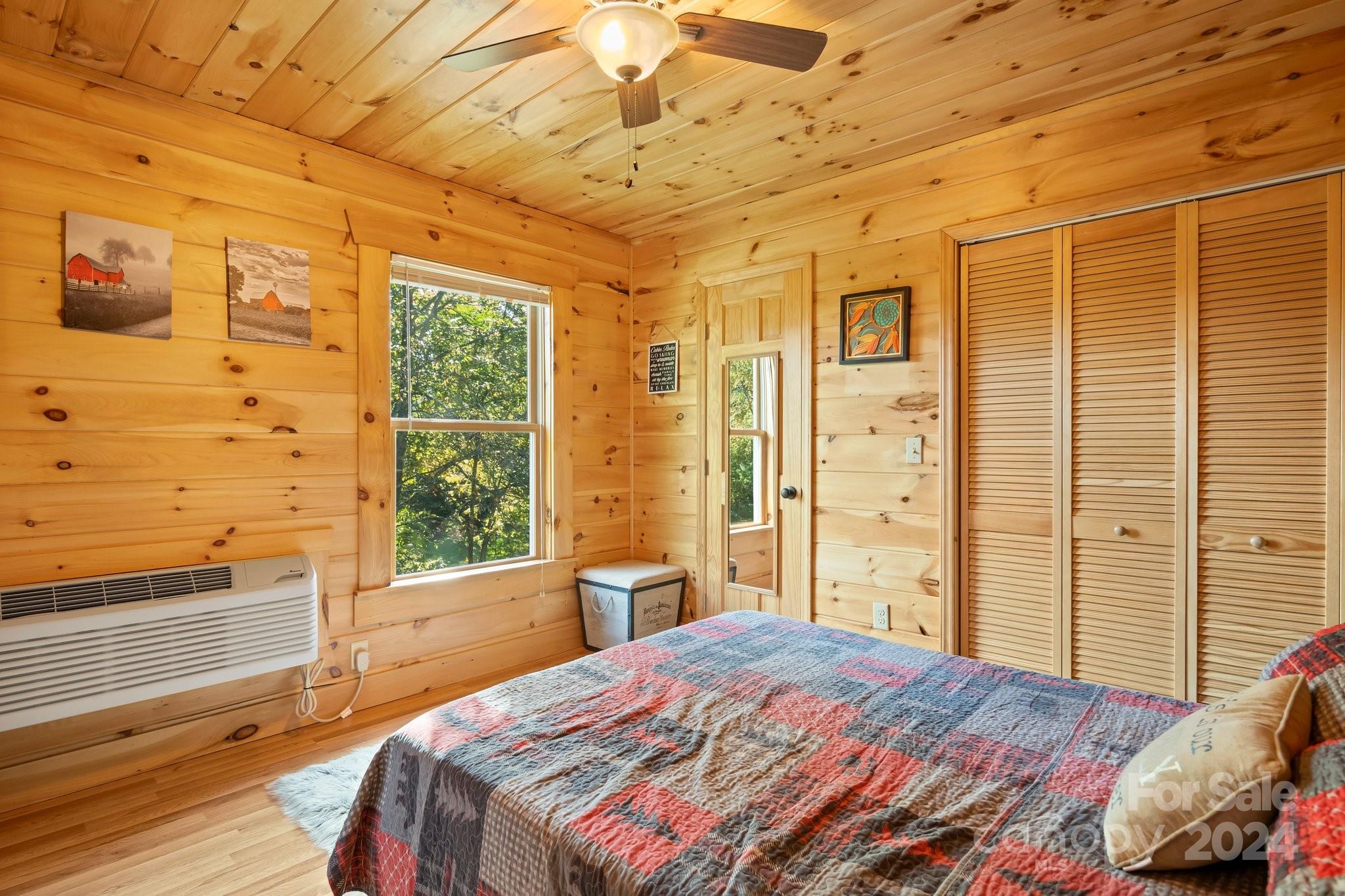 64 Bennett Road Candler, NC 28715 - Photo 16 of 24 a bedroom with a bed and wooden floor