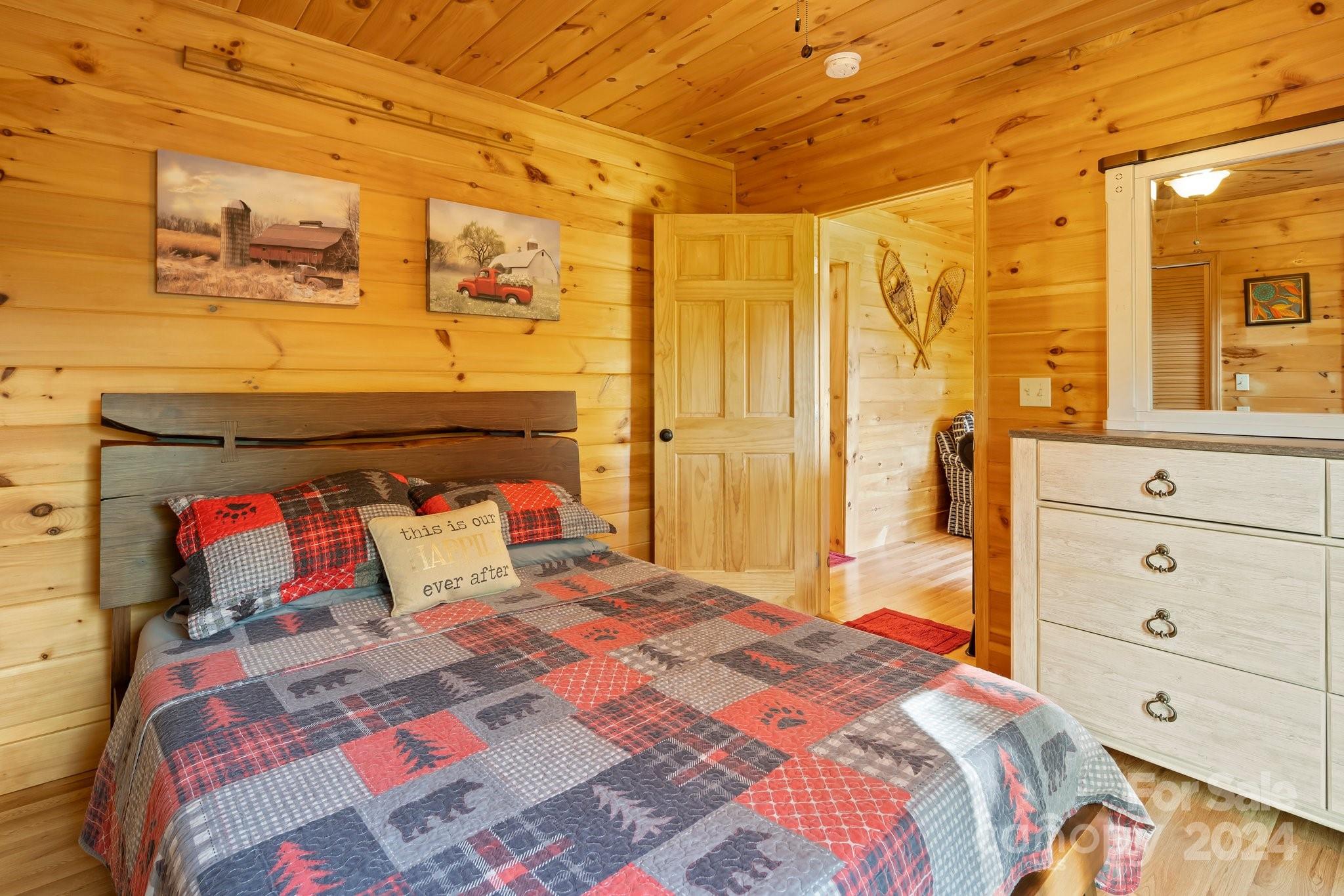 64 Bennett Road Candler, NC 28715 - Photo 17 of 24 a bedroom with a bed and wooden floor