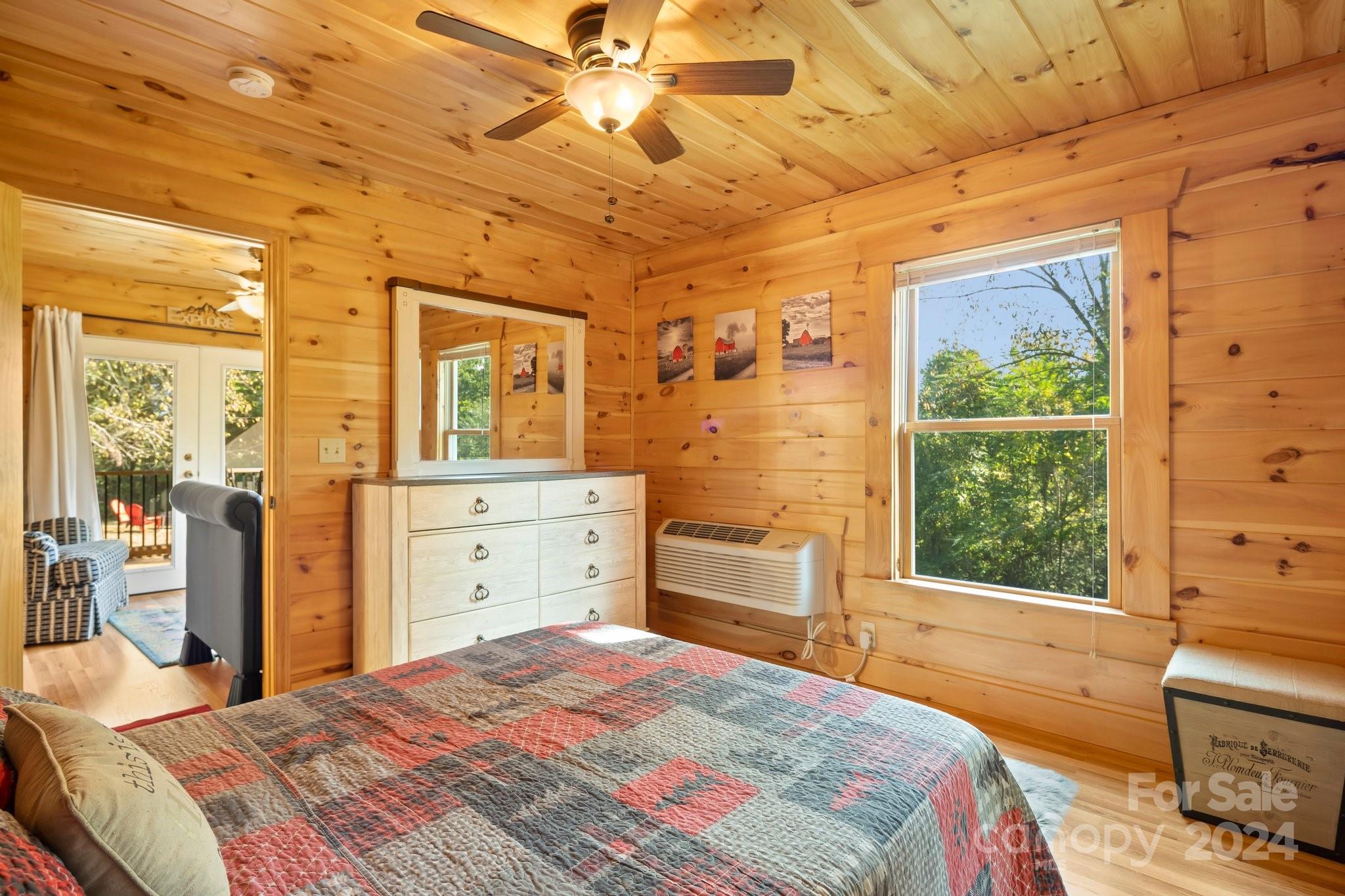 64 Bennett Road Candler, NC 28715 - Photo 18 of 24 a bedroom with a bed and wooden floor