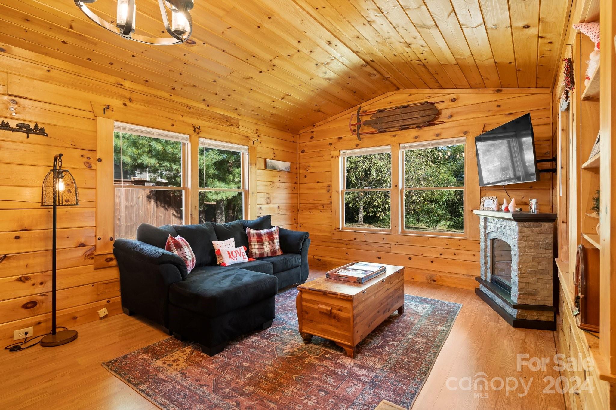 64 Bennett Road Candler, NC 28715 - Photo 6 of 24 a outdoor living space with patio furniture and a fireplace