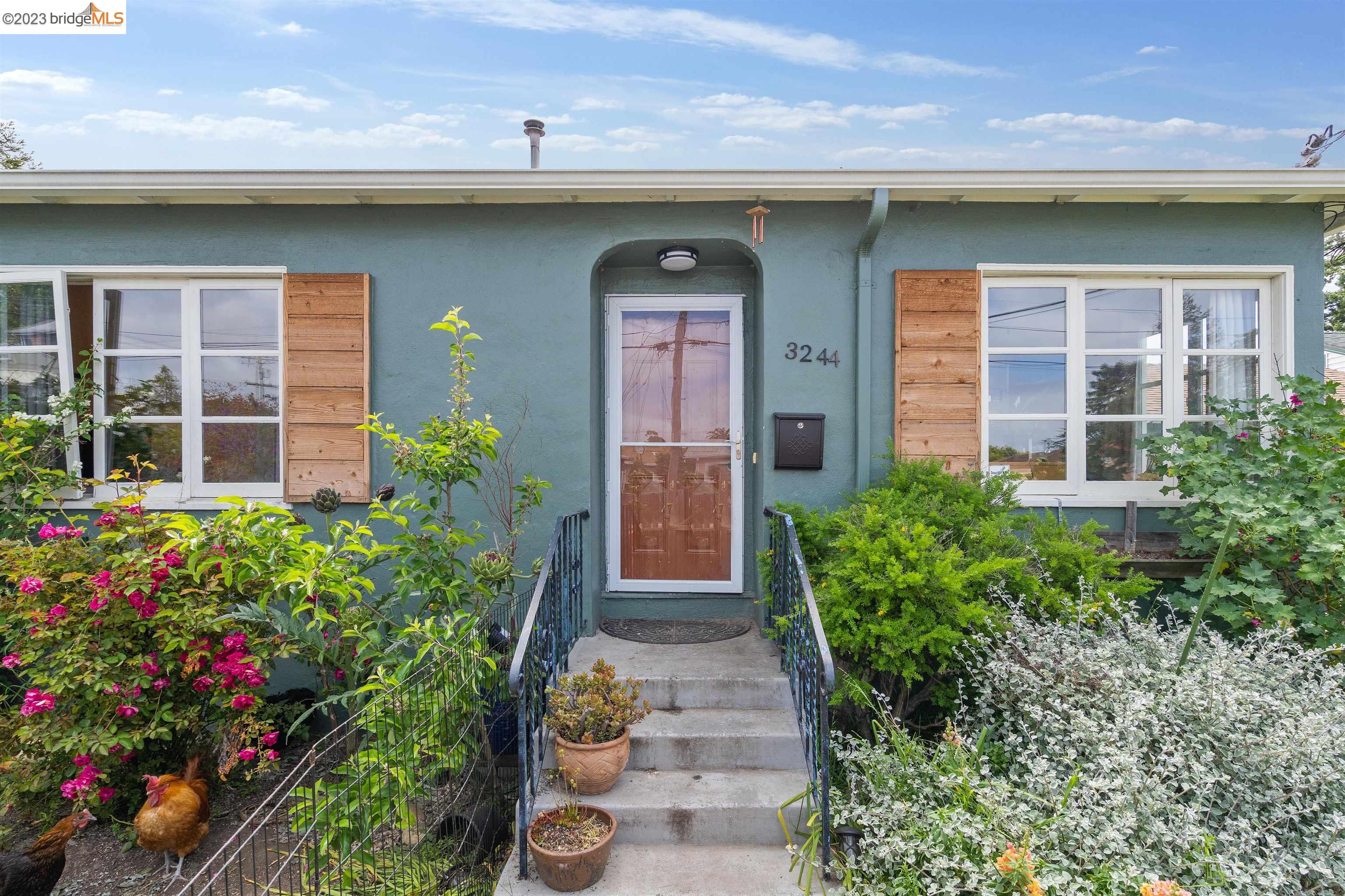 a front view of a house with a garden
