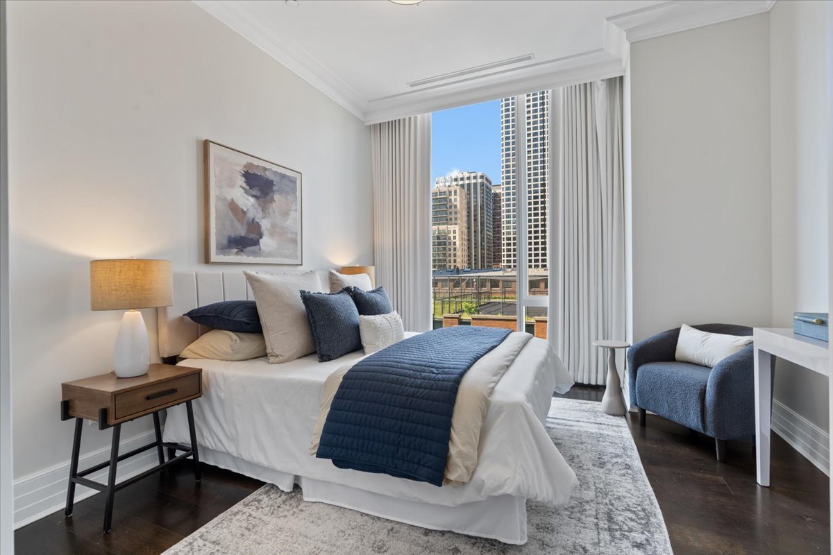 9 West Walton Street, Unit 702 Chicago, IL 60610 - Photo 26 of 38 a bedroom with bed and a couch