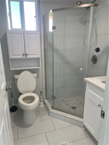 a bathroom with a shower and a sink a mirror