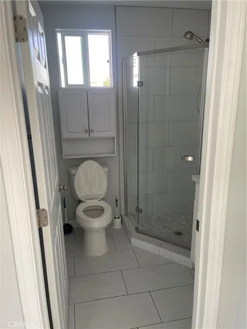 a bathroom with a shower and a sink a mirror