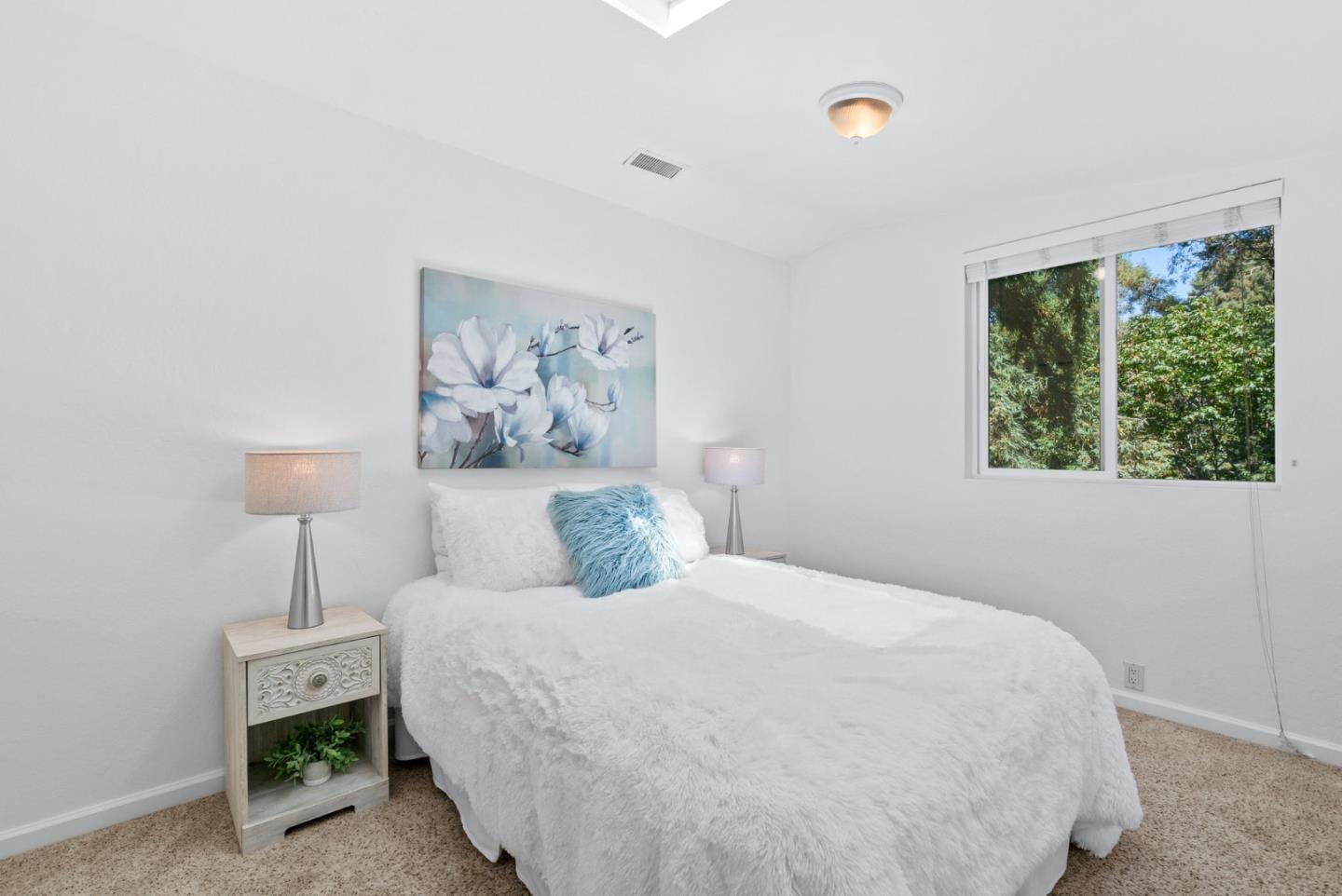 115 Shadowbrook Road Ben Lomond, CA 95005 - Photo 16 of 51 a bedroom with a bed and a painting on the wall