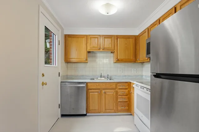 a kitchen with a refrigerator and a sink
