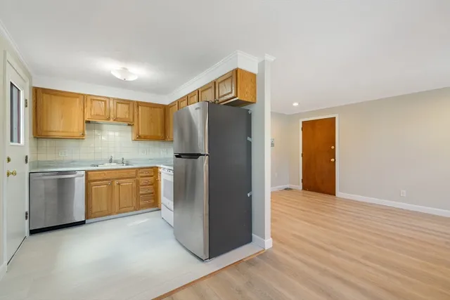 a kitchen with stainless steel appliances granite countertop a refrigerator and a stove top oven
