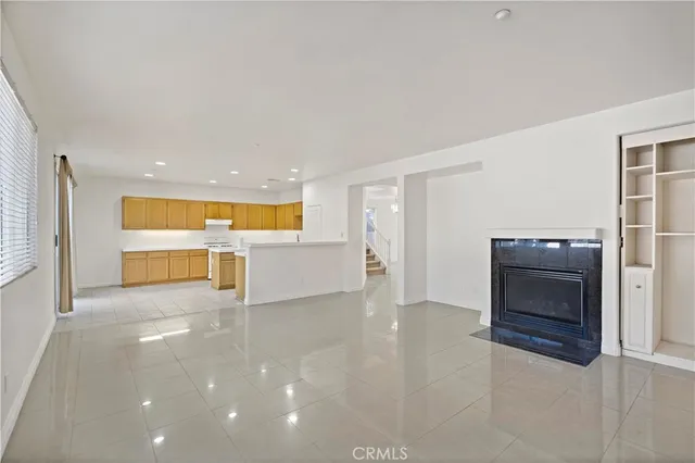 a view of an empty room with a kitchen