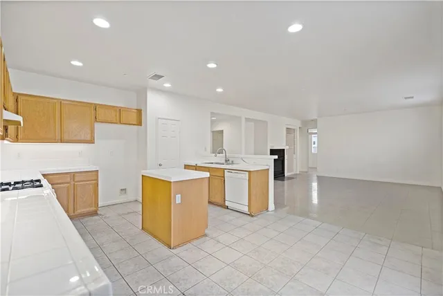 a large kitchen with a sink and cabinets