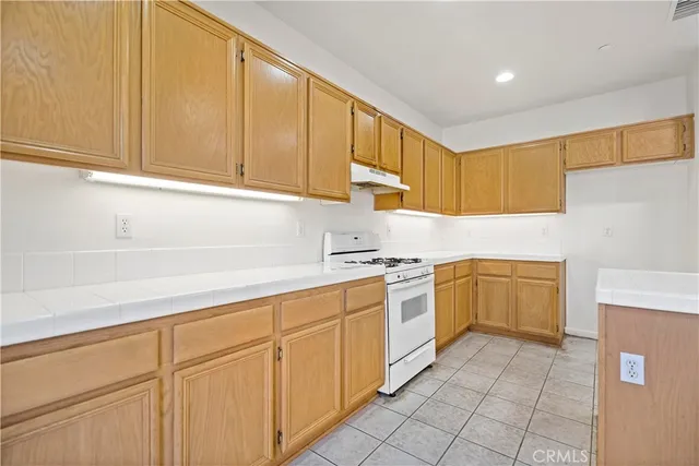 a kitchen with white cabinets a sink and dishwasher