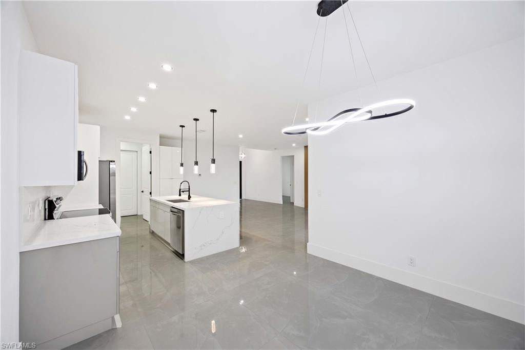 3908 Sunset Road Lehigh Acres, FL 33971 - Photo 11 of 30 a large white room with white walls
