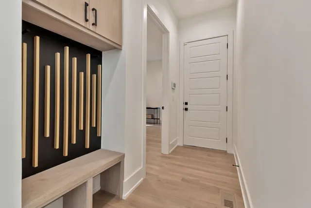 a view of a hallway with wooden floor and staircase