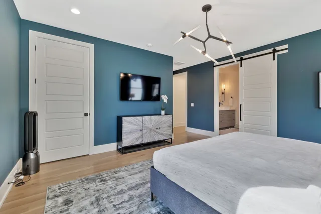 a bedroom with a bed and a flat screen tv