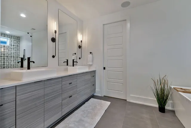 a bathroom with a double vanity sink a mirror and a shower