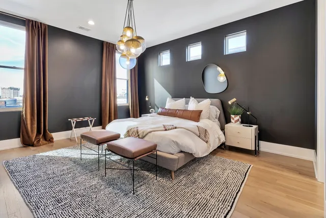 a bed room with a bed mirror and a window