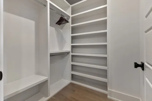 a view of walk in closet with empty racks