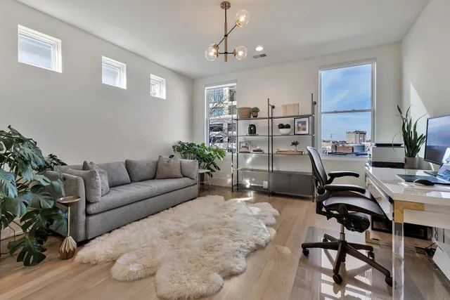 a workspace with furniture and a chandelier