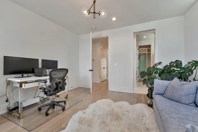 a view of a livingroom with workspace and a couch