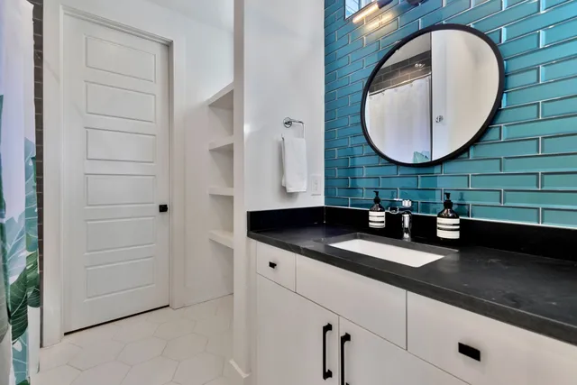 a bathroom with a granite countertop sink and a mirror