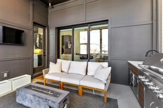 a living room with furniture a flat screen tv and a fireplace