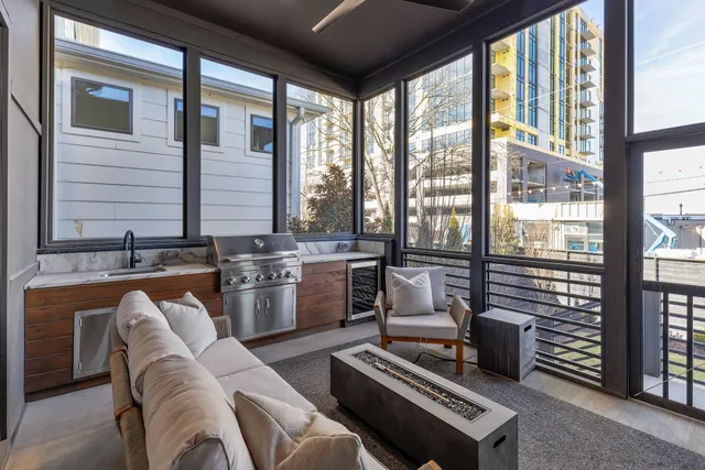 a living room with furniture and large windows