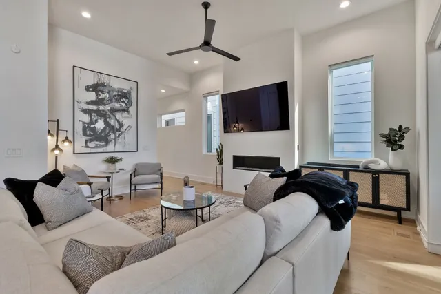 a living room with furniture a fireplace and a flat screen tv