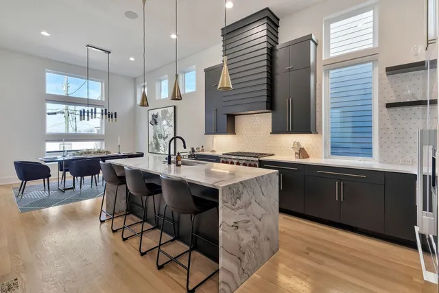 a kitchen with granite countertop a sink appliances and cabinets