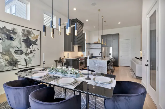 a dining room with furniture and wooden floor