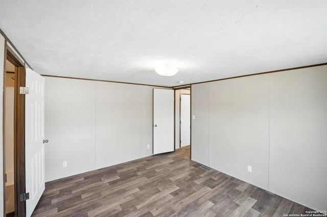 an empty room with windows and closet