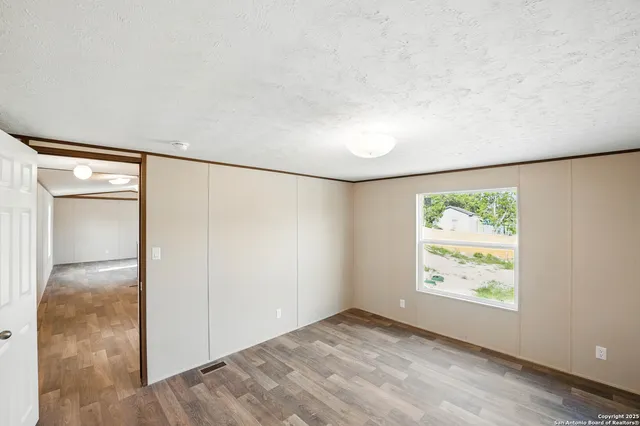 a view of hallway with wooden floor