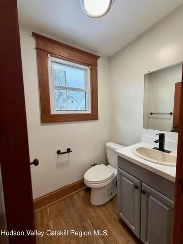 a bathroom with a sink a toilet and mirror