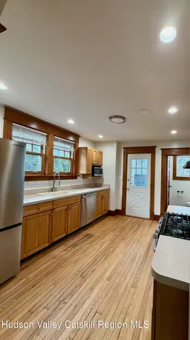 a kitchen with stainless steel appliances kitchen island granite countertop a stove a sink and a refrigerator