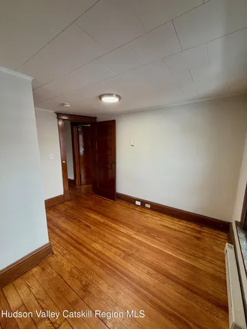 a view of an empty room with closet
