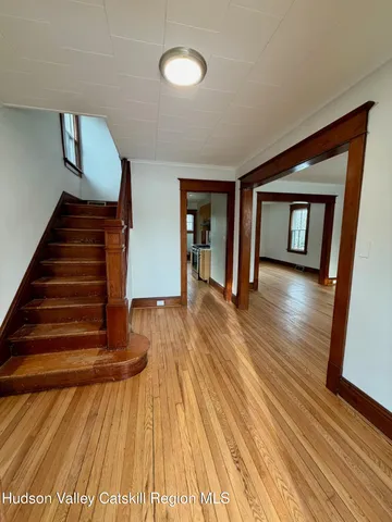 a view of an entryway with wooden floor