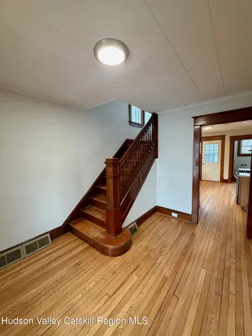 a view of an entryway with wooden floor