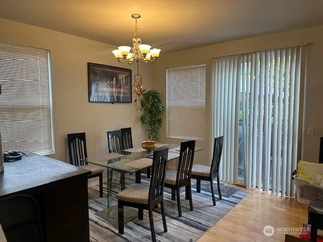 a view of a dining room with furniture and a chandelier