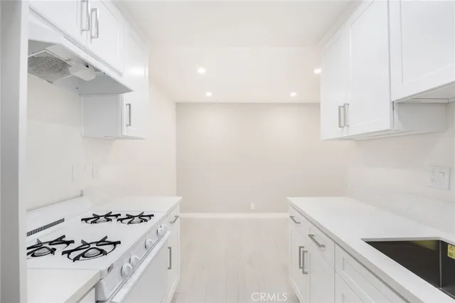 a bathroom with a sink and a refrigerator