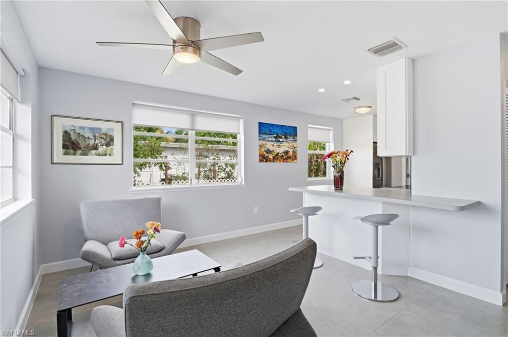 4518 West Alhambra Circle Naples, FL 34103 - Photo 11 of 40 a living room with furniture and a window