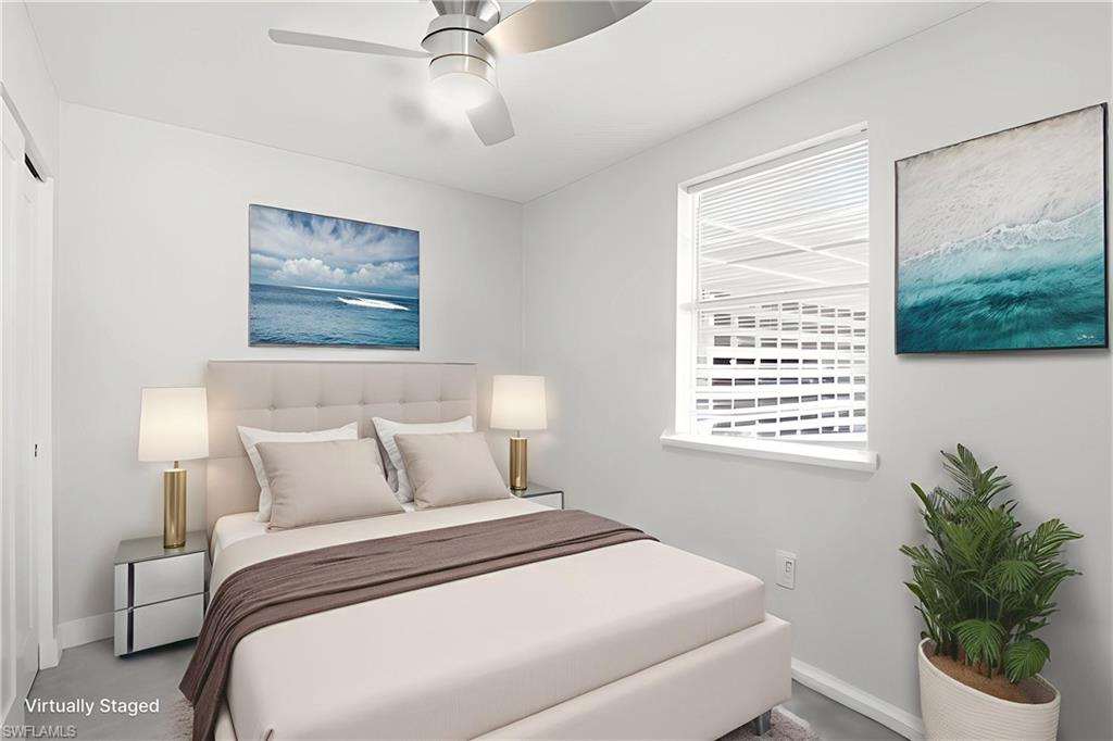 4518 West Alhambra Circle Naples, FL 34103 - Photo 19 of 40 a bedroom with a large bed and a window