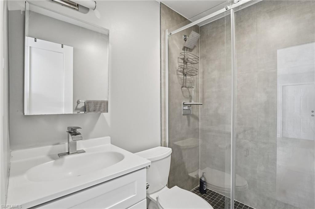4518 West Alhambra Circle Naples, FL 34103 - Photo 20 of 40 a bathroom with a sink toilet and shower