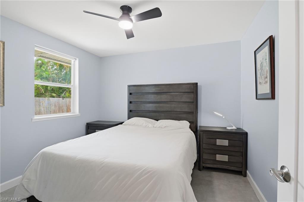 4518 West Alhambra Circle Naples, FL 34103 - Photo 21 of 40 a bedroom with a bed and a tv