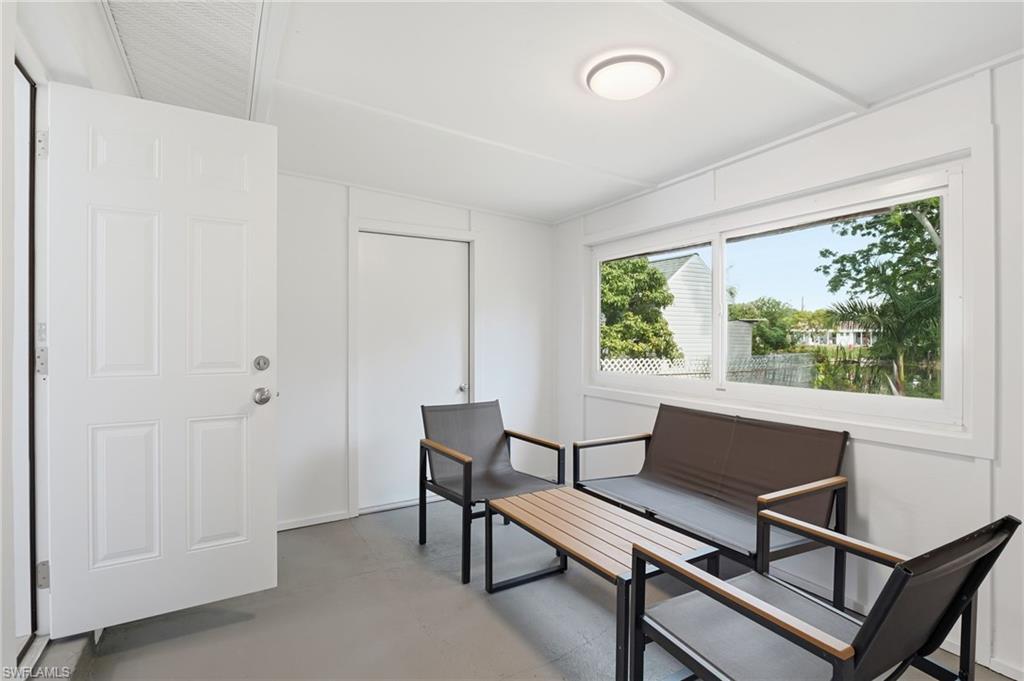4518 West Alhambra Circle Naples, FL 34103 - Photo 22 of 40 a view of a livingroom with furniture and a window