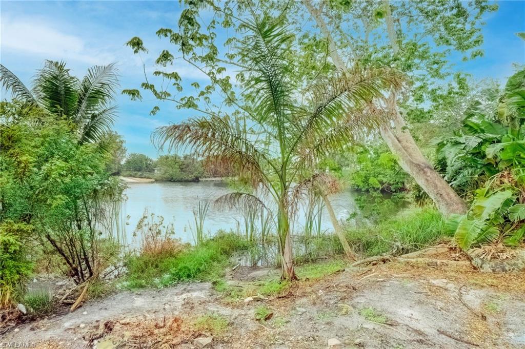 4518 West Alhambra Circle Naples, FL 34103 - Photo 27 of 40 a backyard of a house with lots of green space and lake view