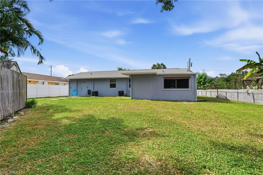 4518 West Alhambra Circle Naples, FL 34103 - Photo 28 of 40 a front view of a house with a garden