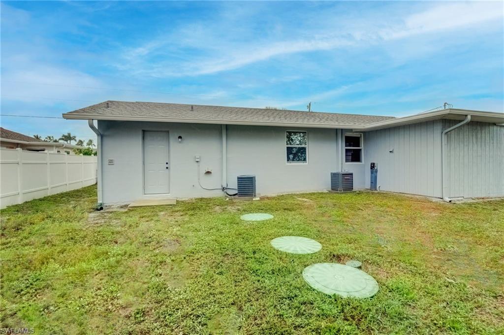 4518 West Alhambra Circle Naples, FL 34103 - Photo 31 of 40 a view of a house with pool and yard
