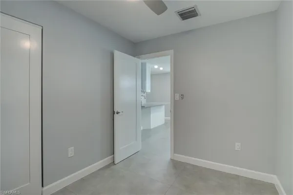 an empty room with closet and a bathroom